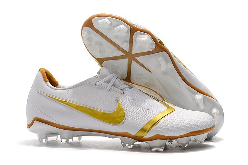 white and gold nike boots